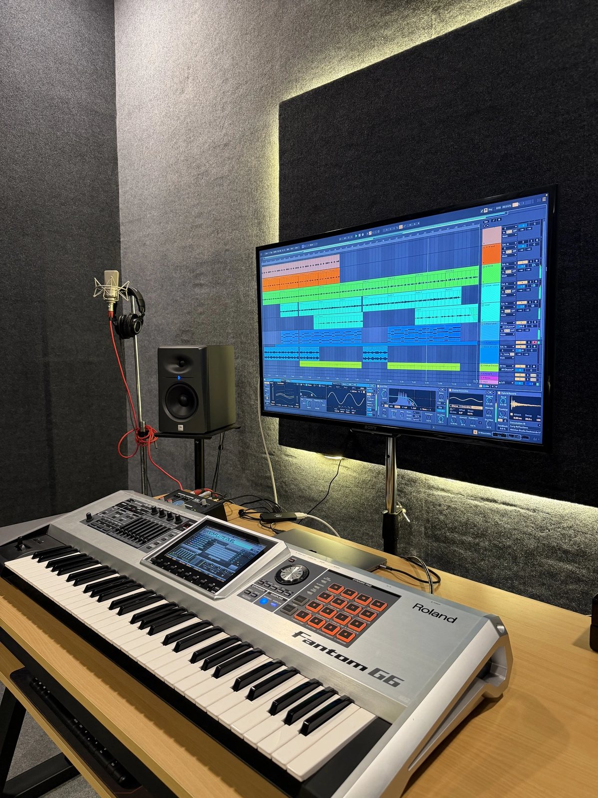 Roland Fantom G6 and studio monitor in front of a session open in Ableton Live